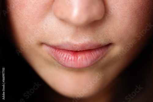 Close up shot of the full lips young woman