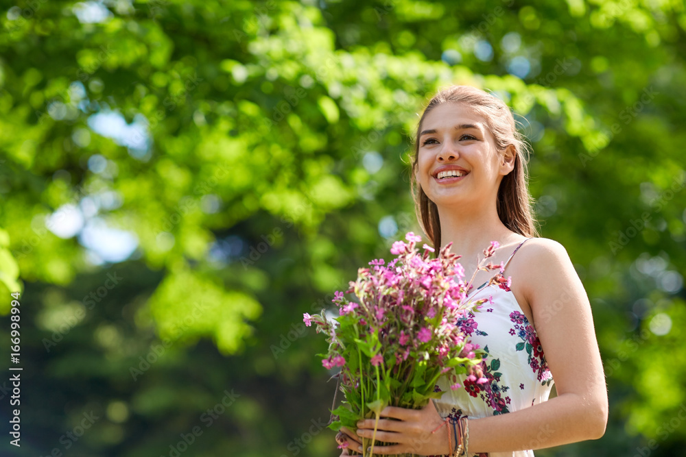 happy young woman with flowers in summer park happy young woman with flowers in summer park