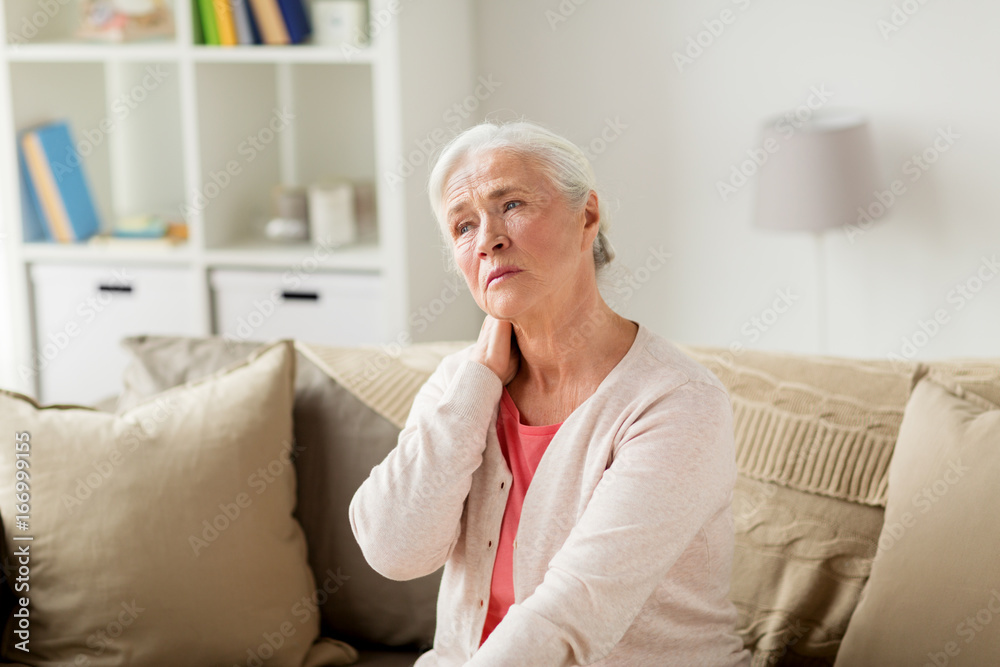 senior woman suffering from neck pain at home senior woman suffering from neck pain at home