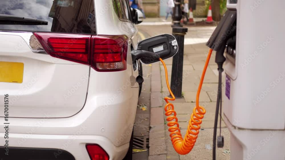 Electric car charging at UK roadside. Electric car charging at UK roadside.