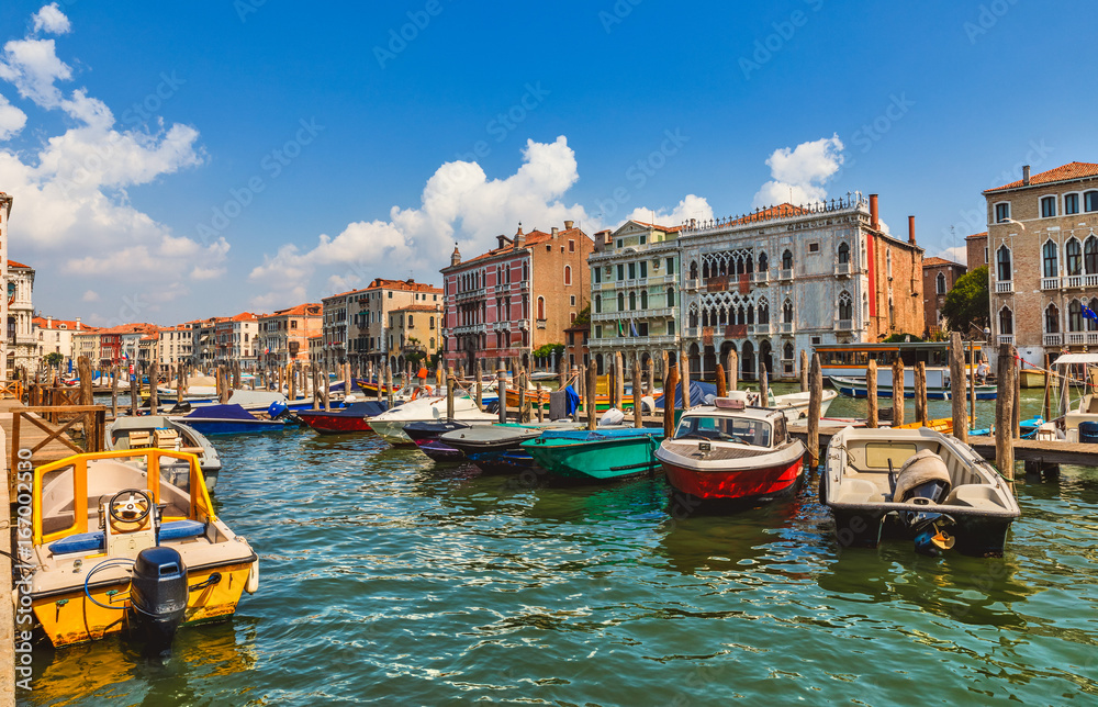 Grand Canal panoramic view Venice Italy with boat by pier blue