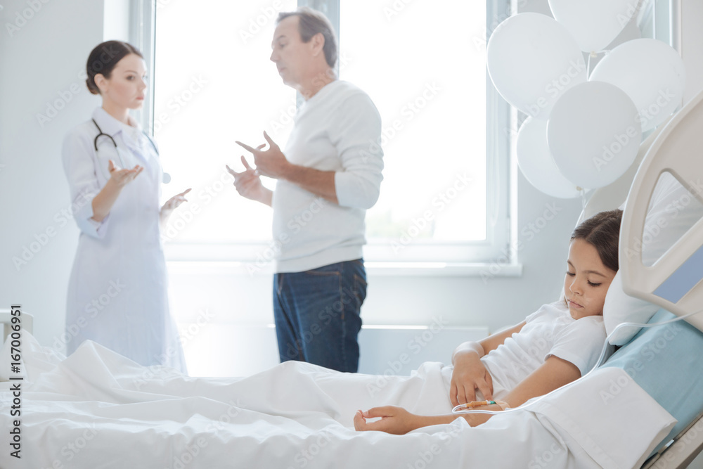 Nice pleasant father and doctor having a conversation Nice pleasant father and doctor having a conversation