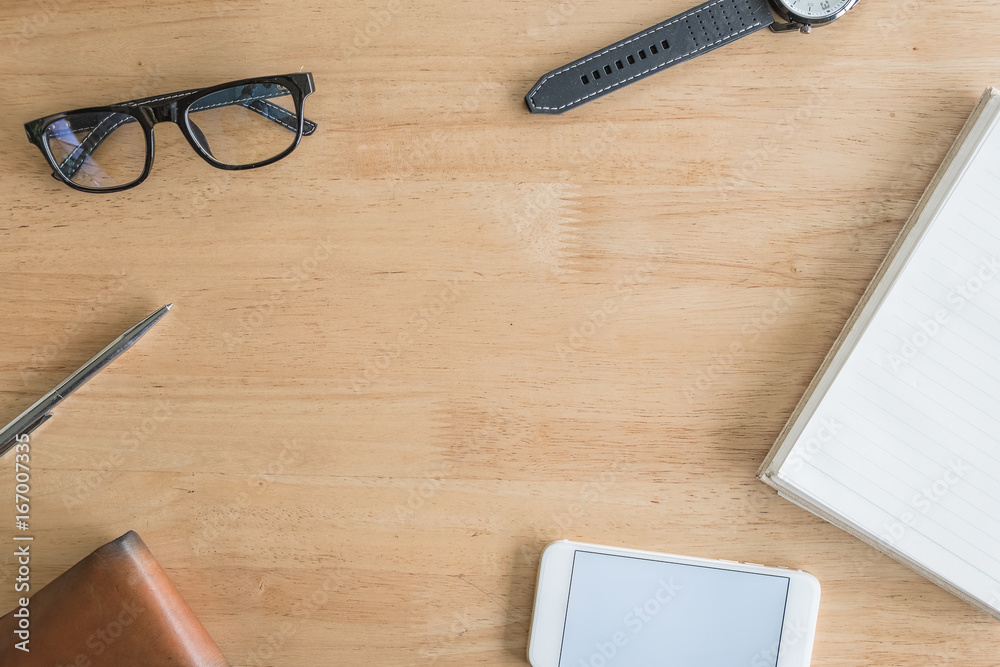 office equipment,laptop computer, smartphone with white screen over a notebook and cup of coffee. Top view with copy space, flat lay. office equipment,laptop computer, smartphone with white screen over a notebook and cup of coffee. Top view with copy space, flat lay.
