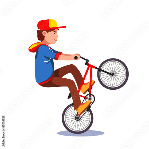Teen kid doing wheelie stunt on a bmx bike