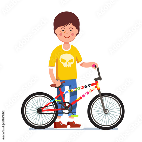 Teen kid standing next to sticker bombed bmx bike