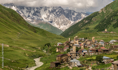 Panoramic view of village Ushguli with old stone towers under the highest georgian mountain Shkhara with glacier in Svaneti, Caucasus, Georgia