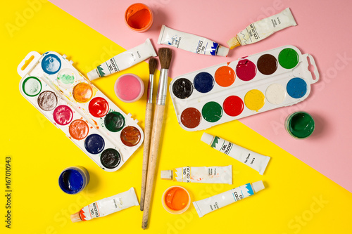 Paints brushes pencils paper colors mock up
