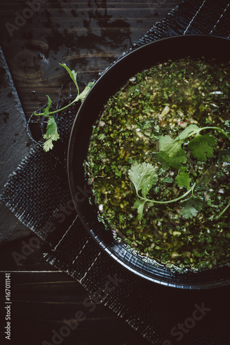 Green chimichurri in bowl photo