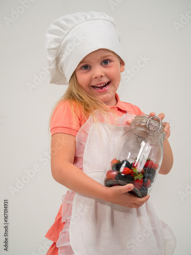 cheerful girl with a jar of berries
