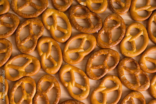 Background texture of salted savory mini pretzels in the traditional looped knot shape. Top view full frame from overhead. photo