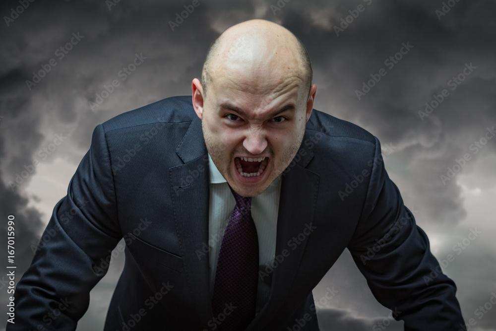 Angry boss. Businessman in suit with very angry face screaming. Stock