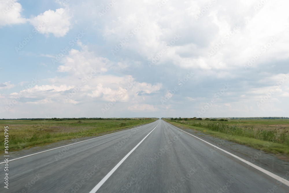 The road going into the distance between fields The road going into the distance between fields