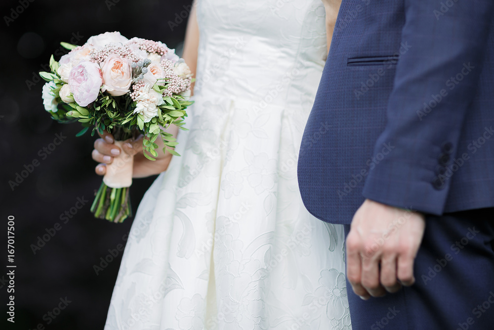 bride and groom holding wedding bouquet bride and groom holding wedding bouquet