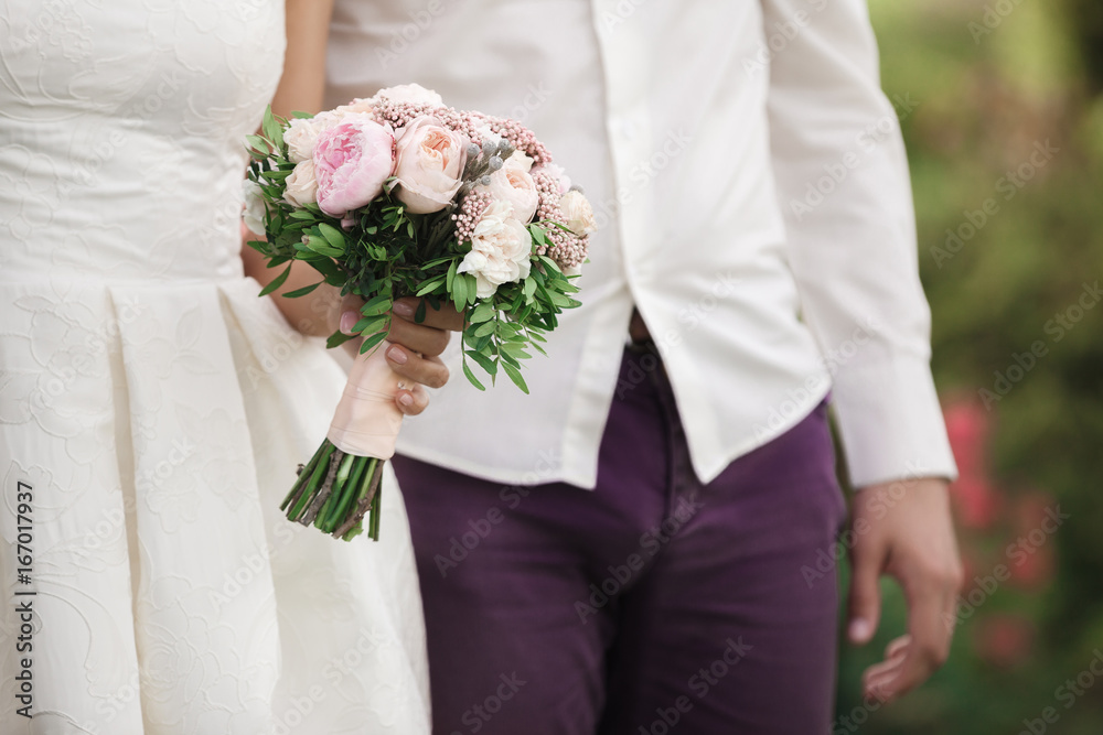 bride and groom holding wedding bouquet bride and groom holding wedding bouquet
