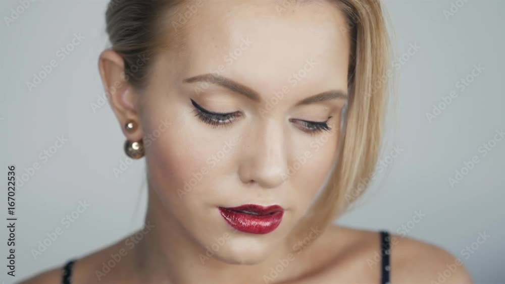 beautiful woman with bright glamour make-up. Red lips and nails. Blonde hair. Clean skin. Dark backgroud, sexy model beautiful woman with bright glamour make-up. Red lips and nails. Blonde hair. Clean skin. Dark backgroud, sexy model
