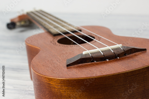 Close up of ukulele on old wooden background photo