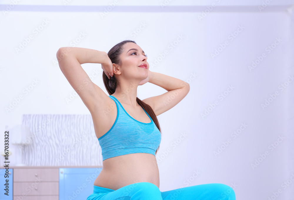 Young pregnant woman training at home. Health concept Young pregnant woman training at home. Health concept