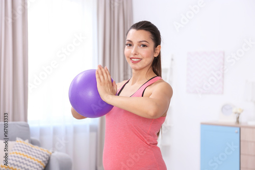 Young pregnant woman traini...