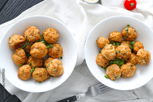 Bowls with delicious turkey meatballs on table
