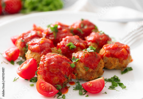 Plate with delicious turkey meatballs and tomato sauce, closeup