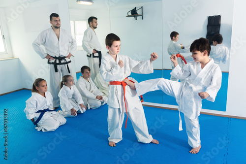 Young boys trying in sparring to use new moves