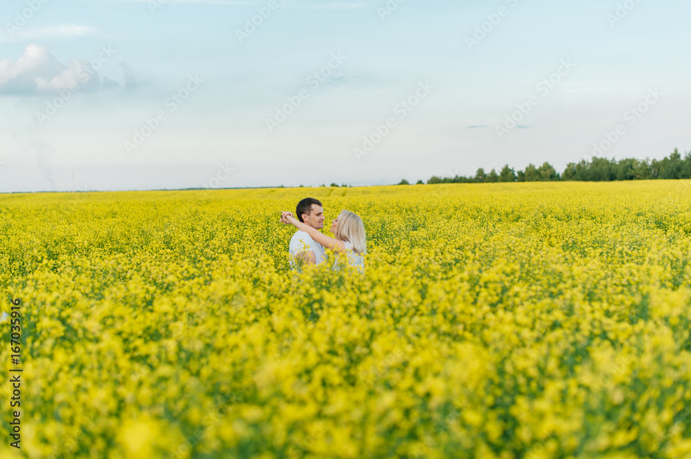Young couple in a yellow field