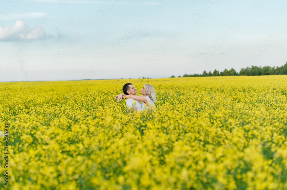 Young couple in a yellow field