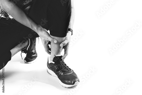 Runner sportsman holding ankle in pain with Broken twisted joint running sport injury and Athletic man touching foot due to sprain on white background