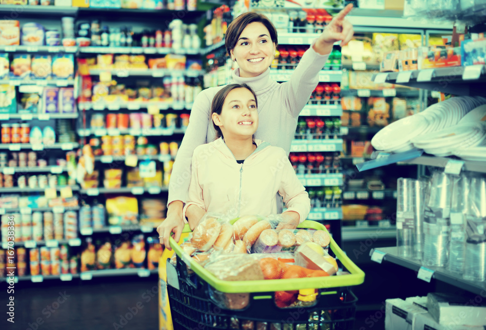 Woman with daughter in supermarket