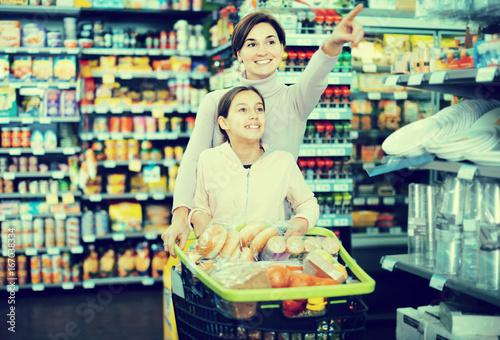 Woman with daughter in supermarket