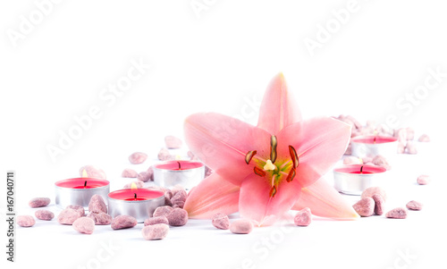 Beauty still life with lily flower  candles and stones isolated on white background