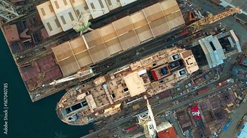 Obraz na płótnie Aerial top down view of unfinished ship at the shipyard