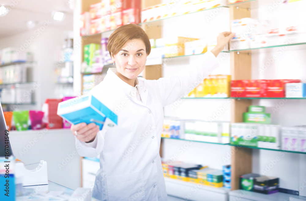 Happy female pharmacist suggesting useful drug