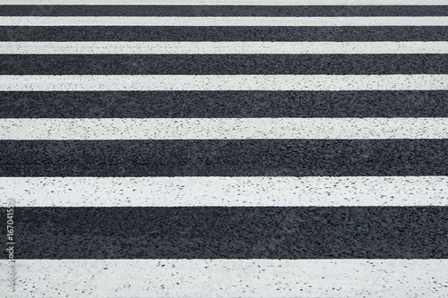 Perspective view of white markings crosswalk lines on a asphalt road (background)