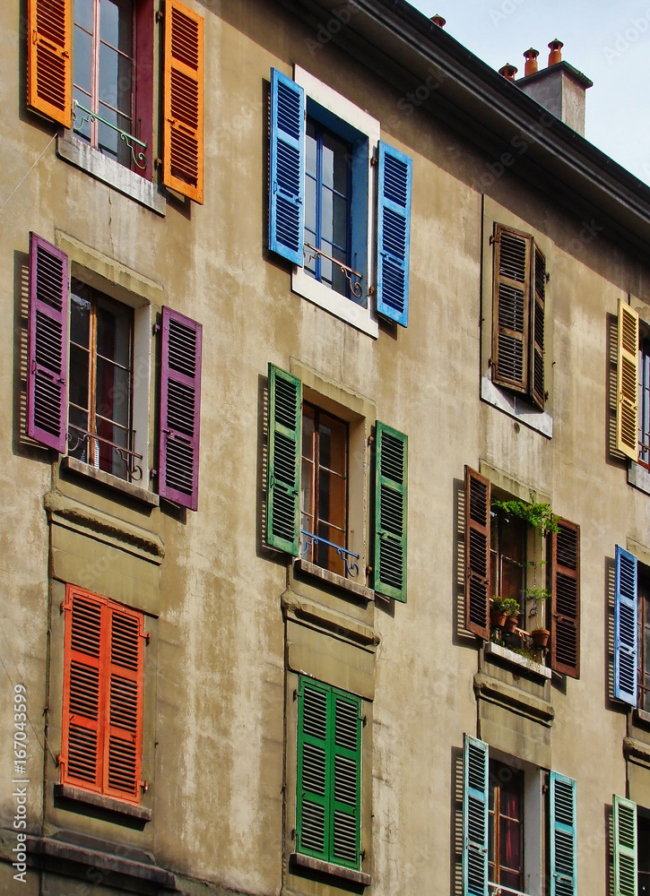 Fototapeta premium Windows with colored shutters, the facade of the house, Europe