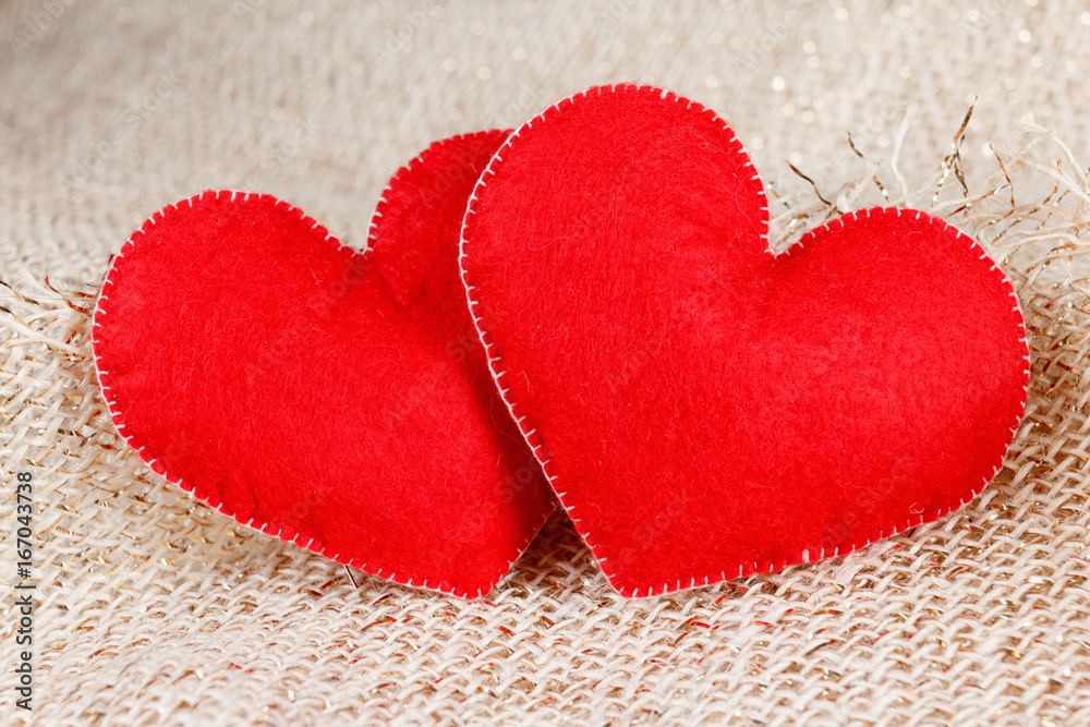 Two hearts symbol of love on burlap background. Two hearts symbol of love on burlap background.