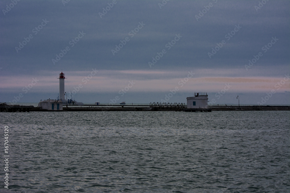 Lighthouse at the entrance to the seaport of Odessa in the evening of July 12, 2017