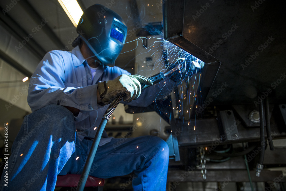 Welder welding on Metal 