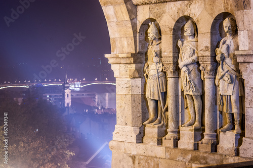 Three stone statues guarding top of stairway to Fisherman's Bastion, in Castle district, Budapest, capital of Hungary