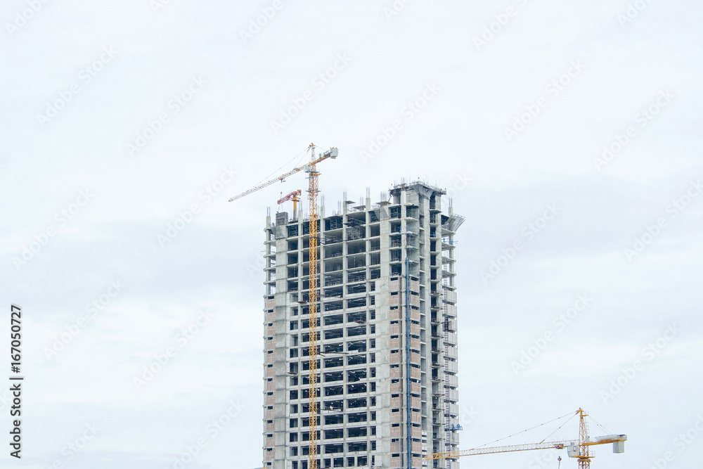 Several cranes are building a building with a white background. Several cranes are building a building with a white background.