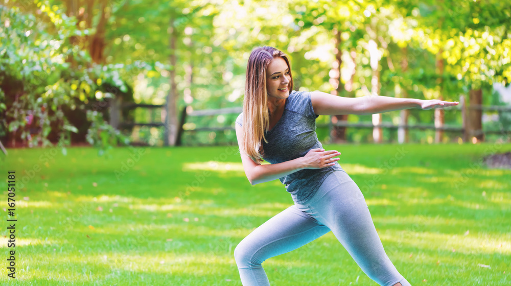 Fit healthy young woman doing stretches outdoors Fit healthy young woman doing stretches outdoors