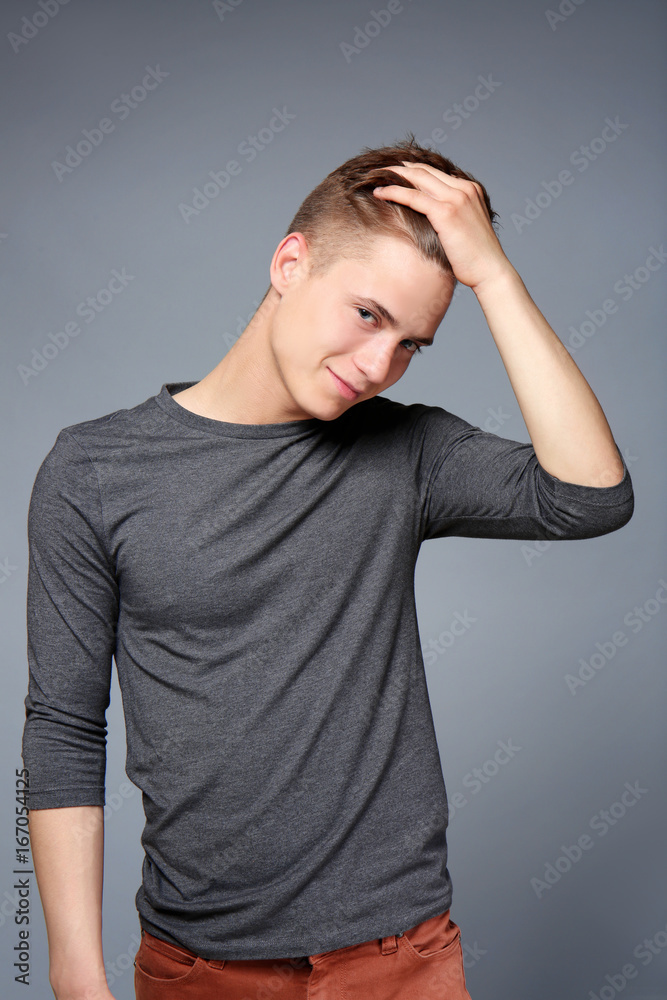 Young teenager posing on grey background Young teenager posing on grey background