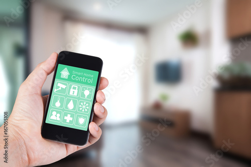 Hand using smartphone to smart home app on mobile for remote control everything in home by wifi network.