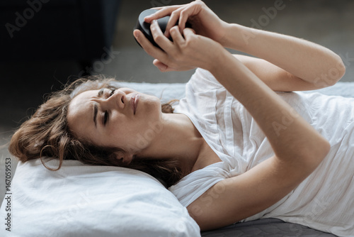 Cheerless unhappy woman not wanting to wake up