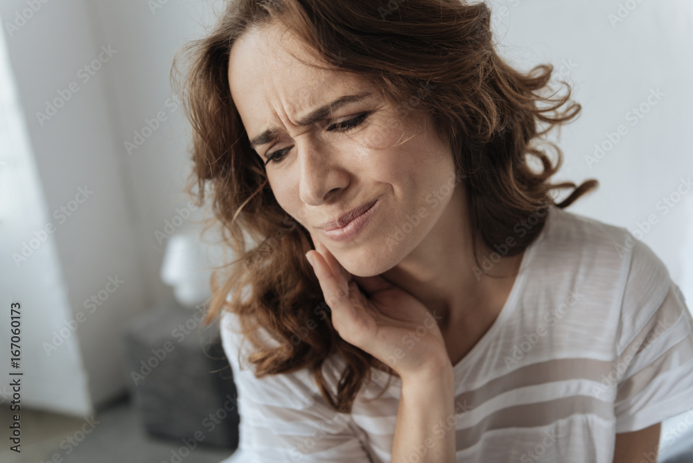 Upset young woman having a toothache Upset young woman having a toothache