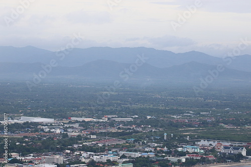 Aerial view of scenic mountain landscape in the fog with cityscape