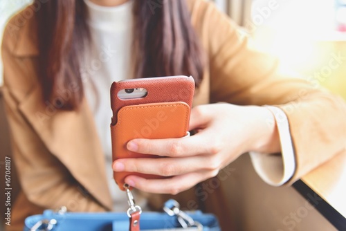 Woman Holding Her Smartphone in a Cafe photo