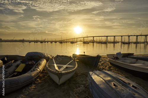 Dinghys on Coronado Island's shore; San Diego and Coronado Bridge in background
