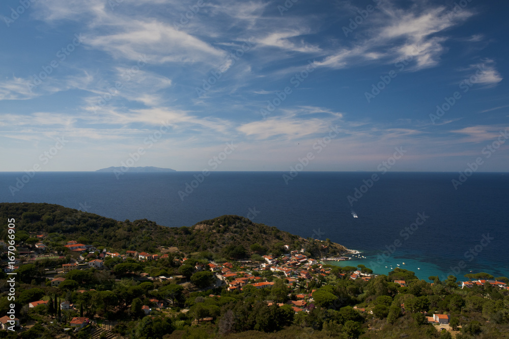 The town of Sant'Andrea overlooks the sea of the island of Elba, in the background the island of montecristo. Italy