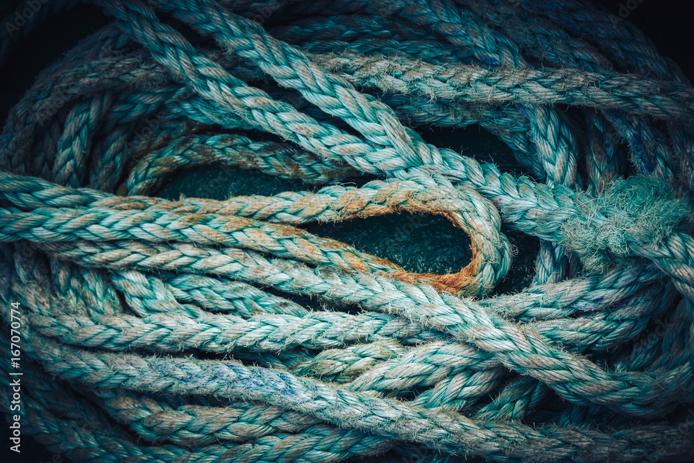 Background texture of coiled marine or nautical rope.Texture of synthethic mooring line. Close up
